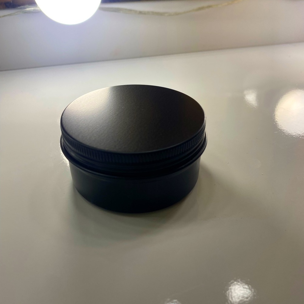 Small black candle tins